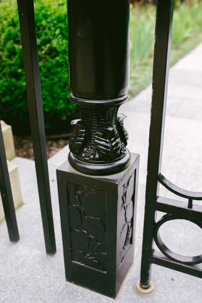 Metal garden gate post with leaf and flower decoration