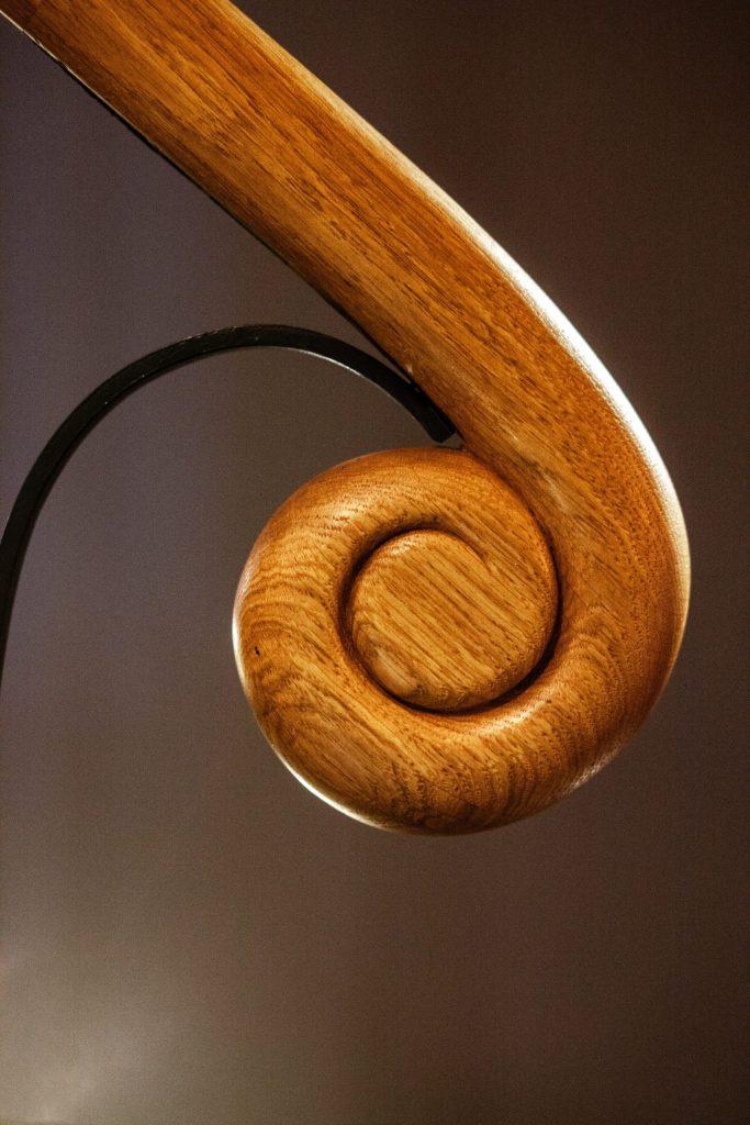 Arts and Crafts Staircase Handrail Metal railings with carved Oak handrail in Arts and Crafts house