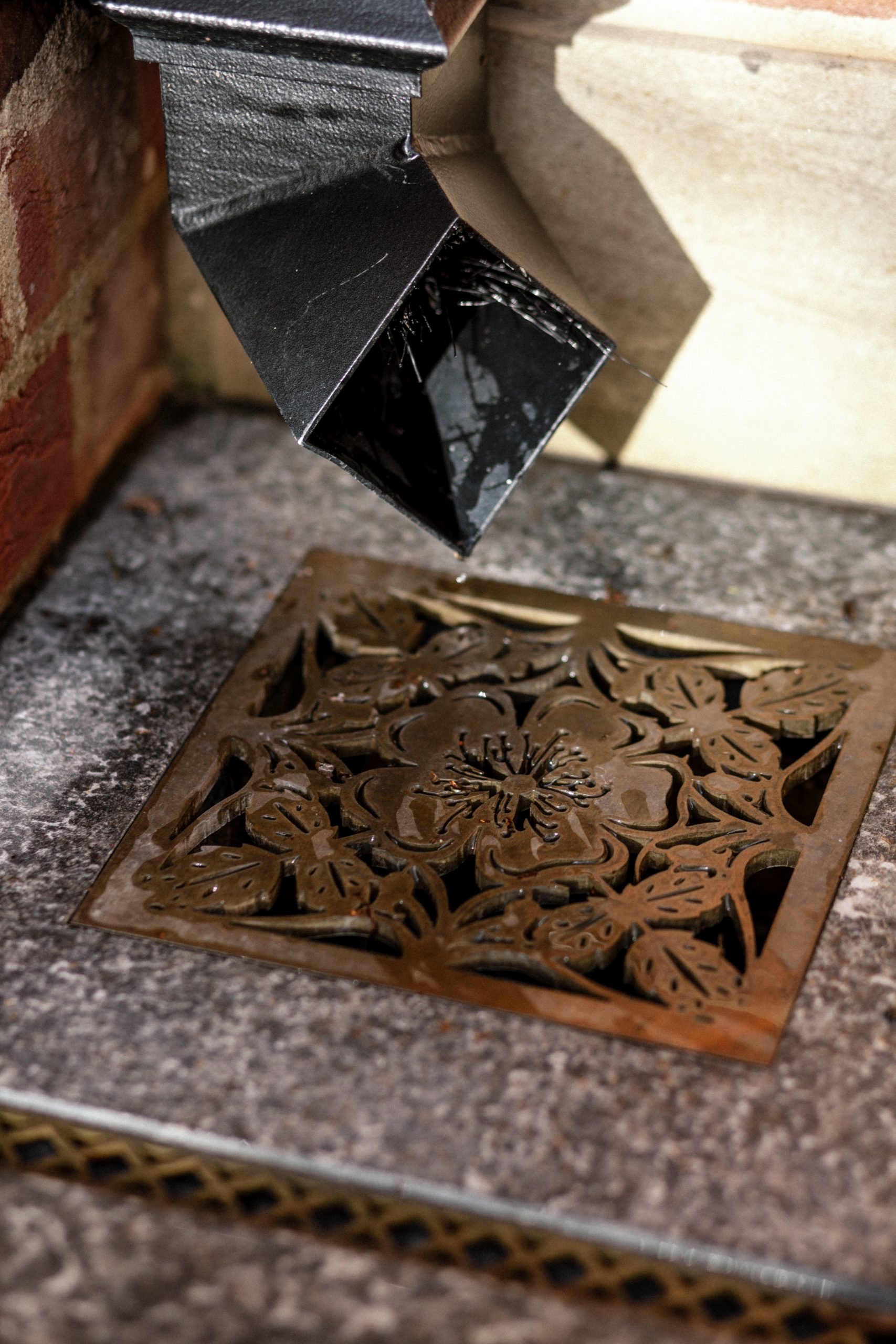 Decorative rainwater trap brasswork Brass inlay into stone
