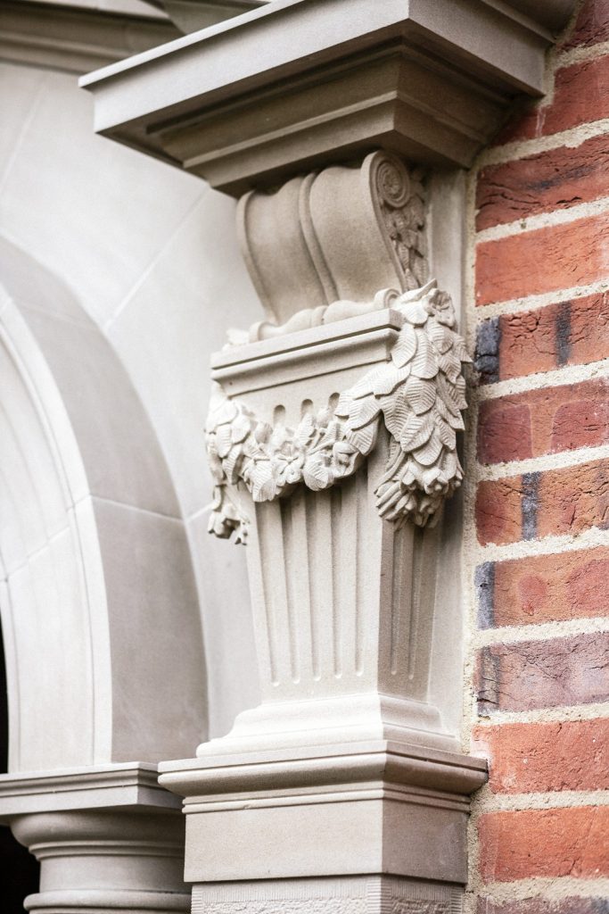 Stone carved scroll corbel with floral swag