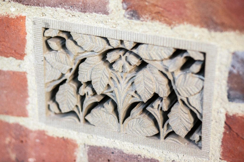 Stone air brick with flowers and leaves Decorative stone air brick with beech leaves and bluebells