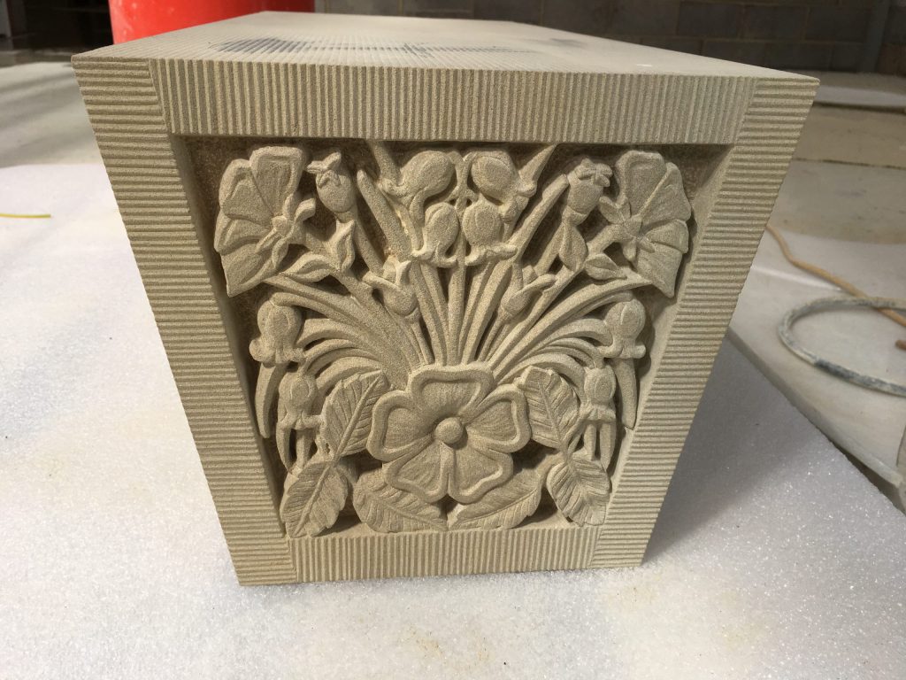 Floral stone carving for keystone on garden building