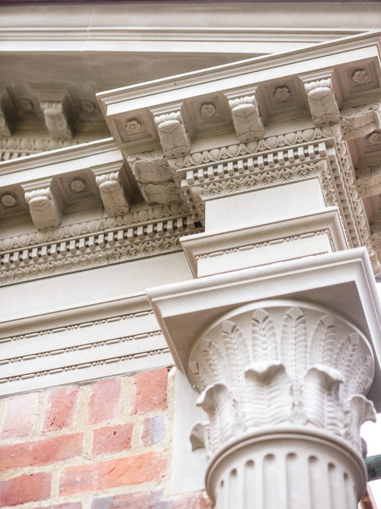 Classical stone and brick garden building with carved details