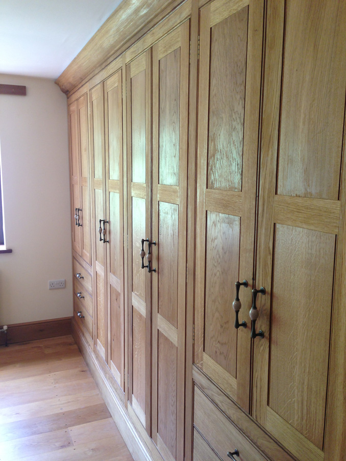 Joiner made fitted Oak wardrobes traditional design