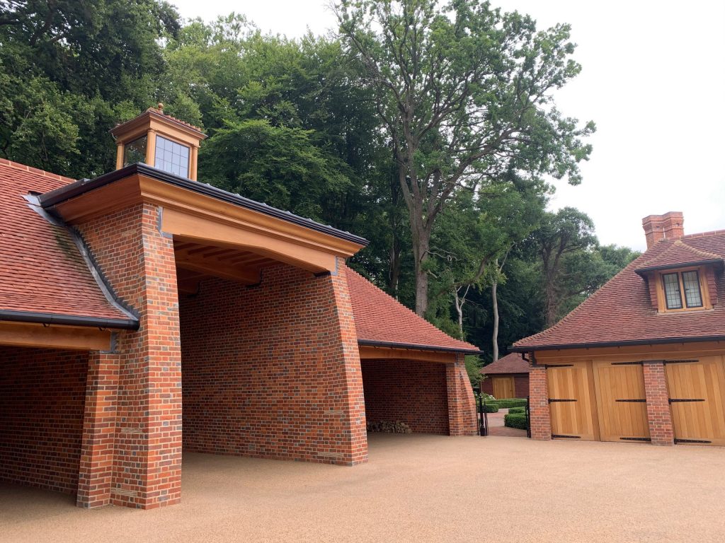 Estate brick entrance building and triple oak garage Entrance courtyard to country house estate