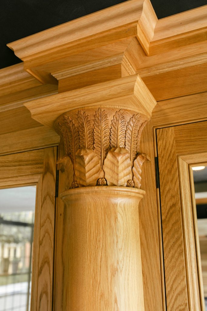 Carved Oak column on Classical fitted cupboards
