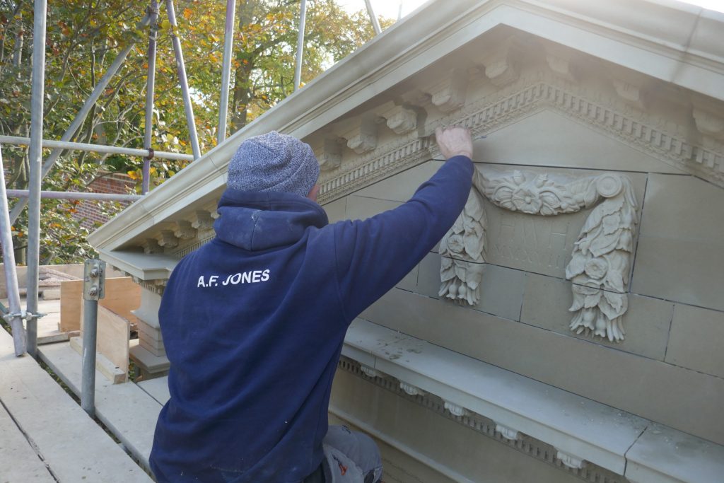Installing Carved Stone Sway Cartouche Award winner for Natural Stone Award craftsmanship