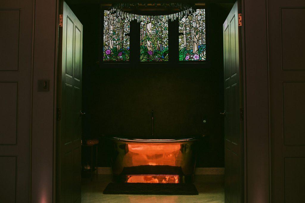 Triptych stained glass window in luxury bathroom