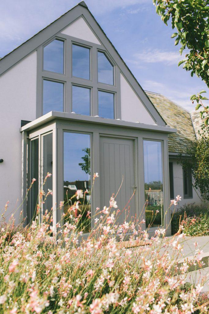 Contemporary grey front door to a traditional country house