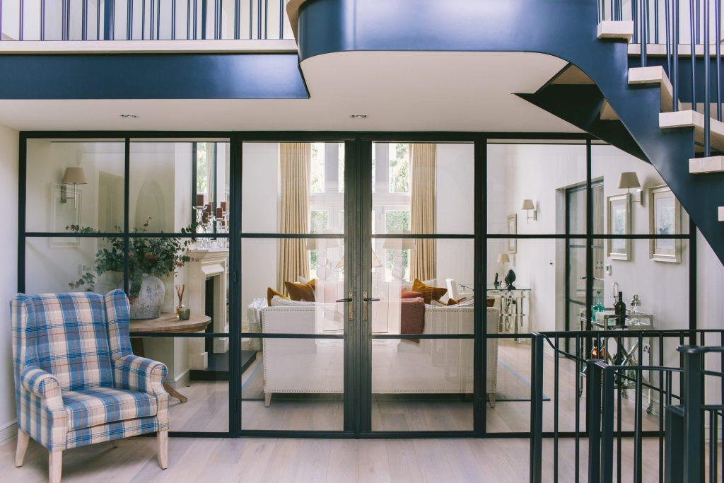 Metal and glass room divider and metal staircase