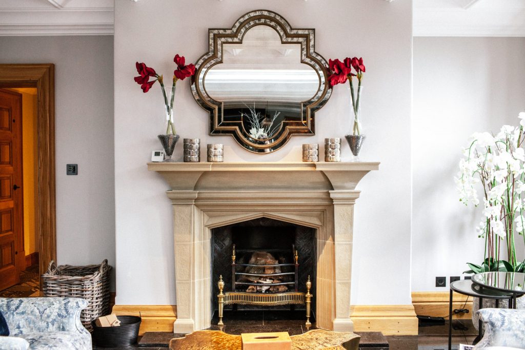 Fluted carved stone fireplace in orangery Sitting room traditional bespoke stone fireplace