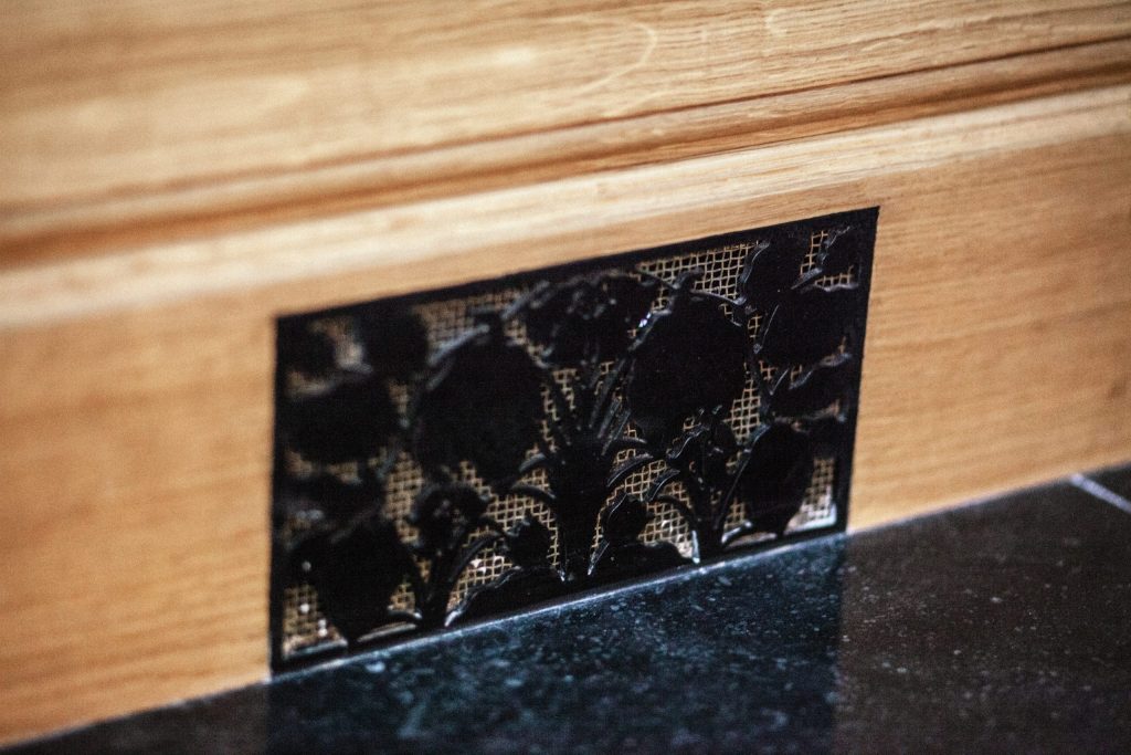 Bespoke vent covers in Oak skirting Bespoke metal vent covers with leaf decoration