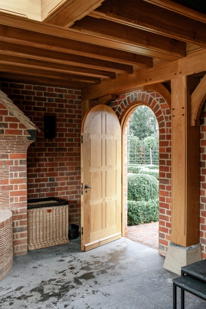 Oak panelled garden door in brick wall