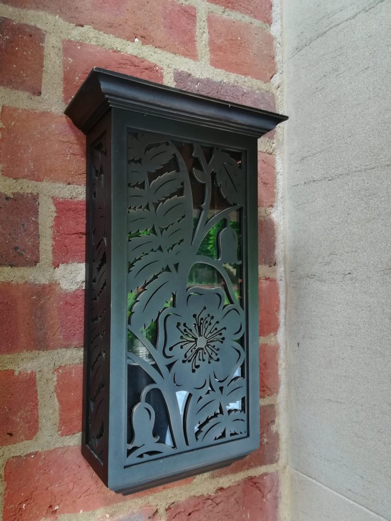 Bronze garden wall lights with cut out metal and glass