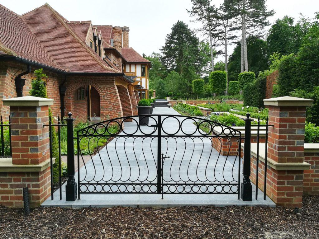 Metal Arts and Crafts gate in country house garden