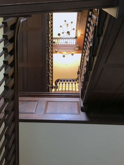 Dark timber bespoke staircase in country house stairwell