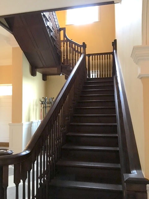 Large dark Oak staircase in house hall