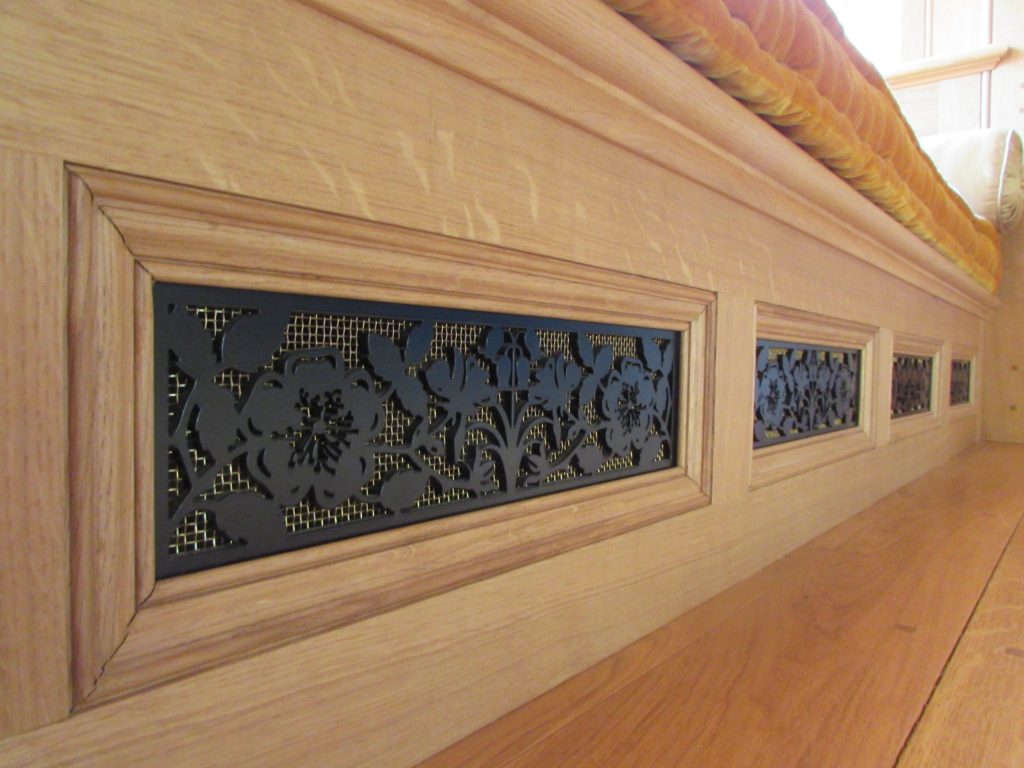 Metal heating vents in Oak window seat Floral heating vents in black metal
