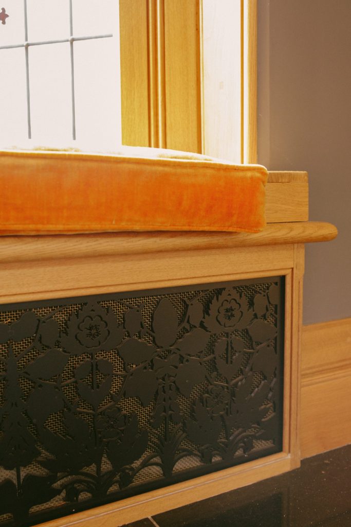 Metal heating vent cover in Oak window seat Arts and Crafts metal decorative panel