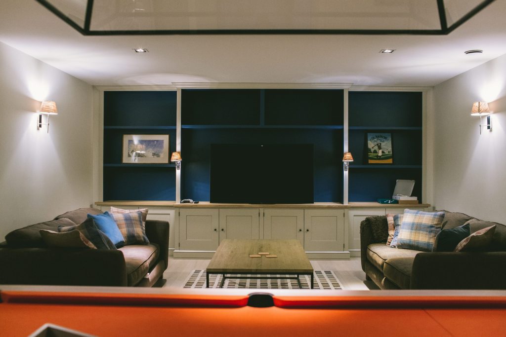 Private cinema and games room with fitted cabinets