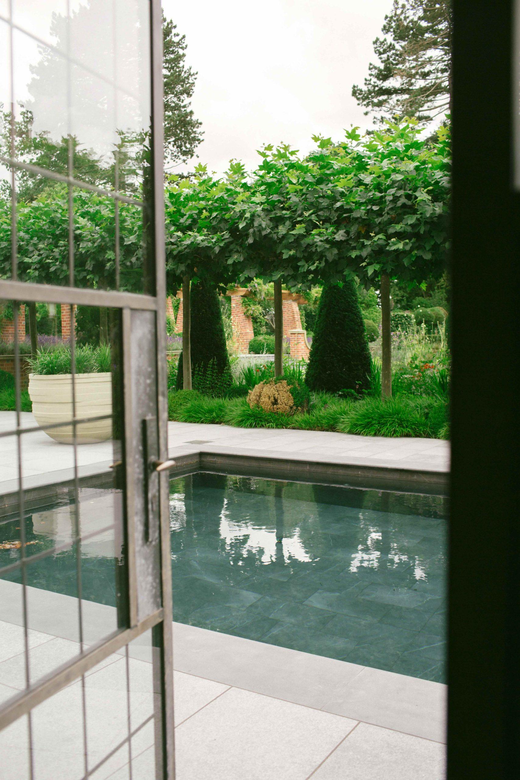 Outdoor fire pit and garden fireplace in Arts and Crafts garden