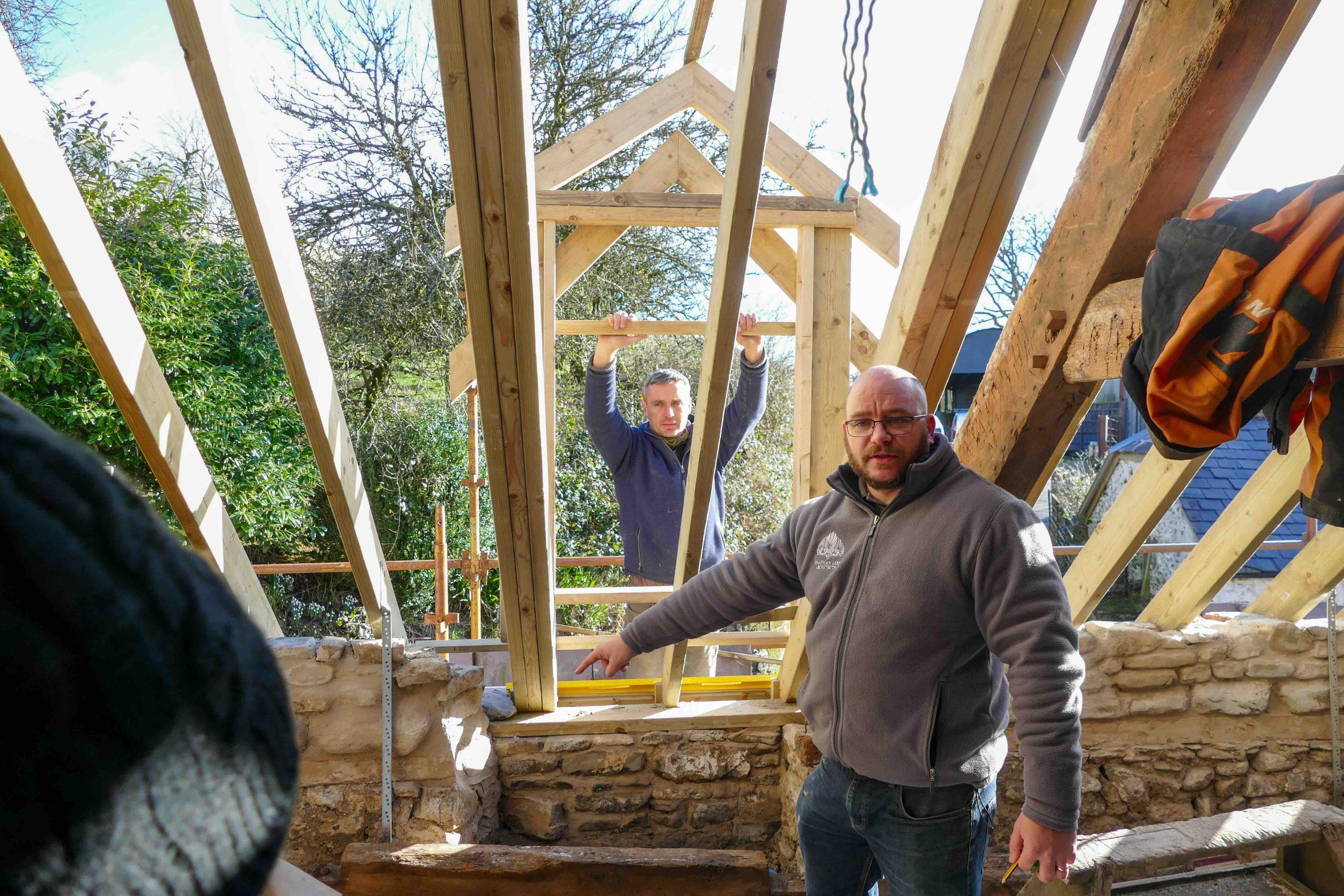Jonathan Lees and Carpenters on site working out the new dormer windows sitting on the historic stone walls of the longhouse.