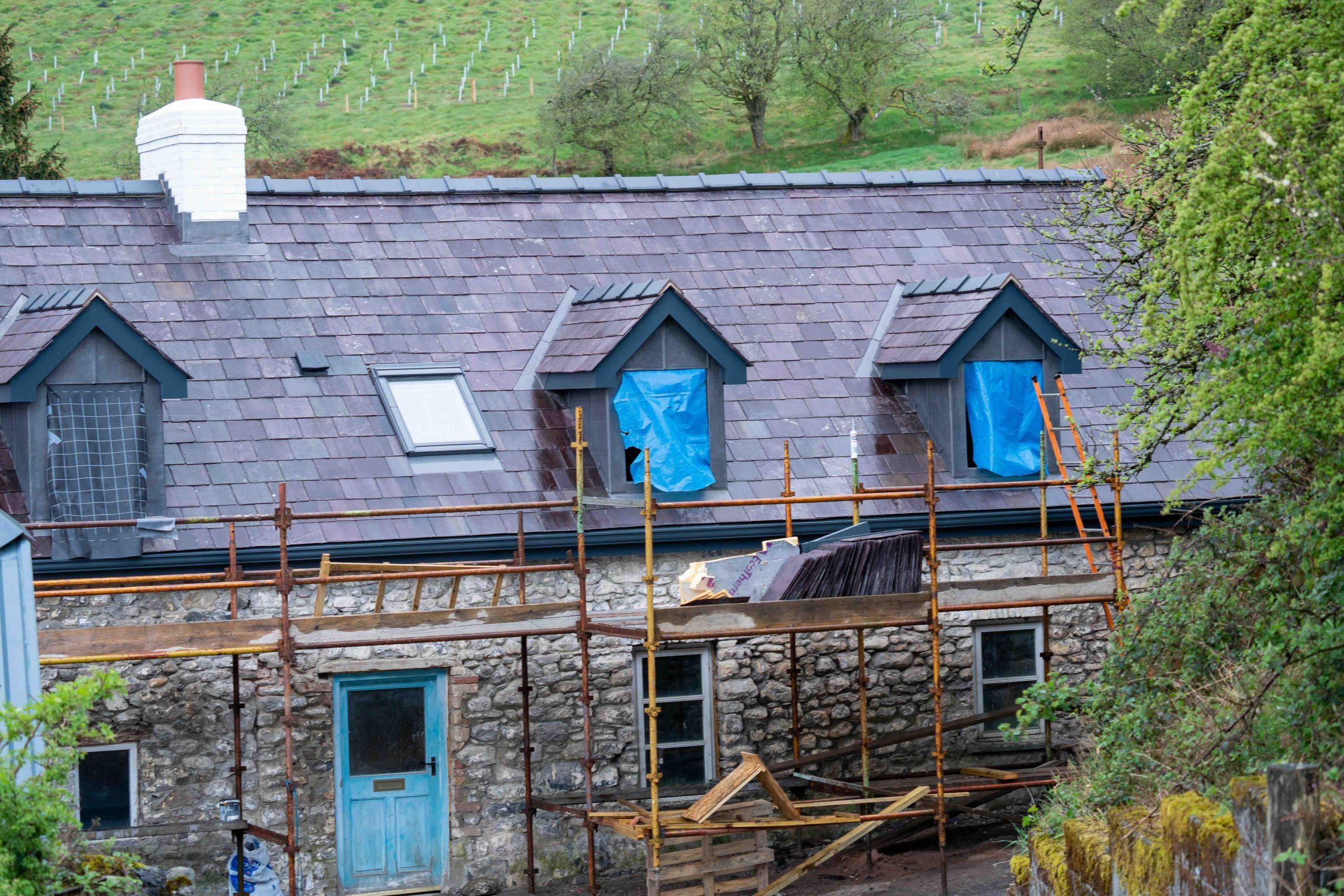 Traditional Welsh longhouse restoration during construction and re-roofing.